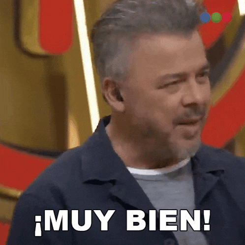 a man with a beard is saying muy bien in spanish