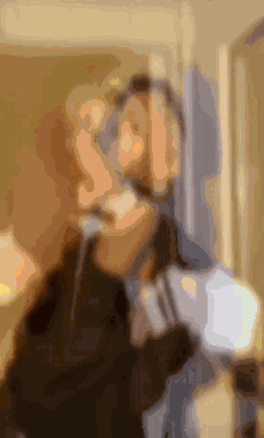 a man with a beard is standing in front of a mirror and looking at himself .