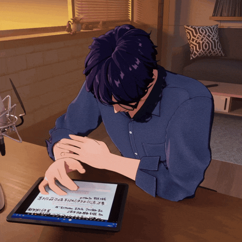 a man in a blue shirt is sitting at a desk using a tablet