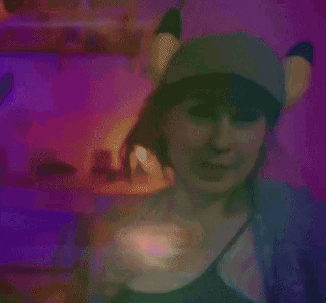 a woman wearing a hat and ears is smiling