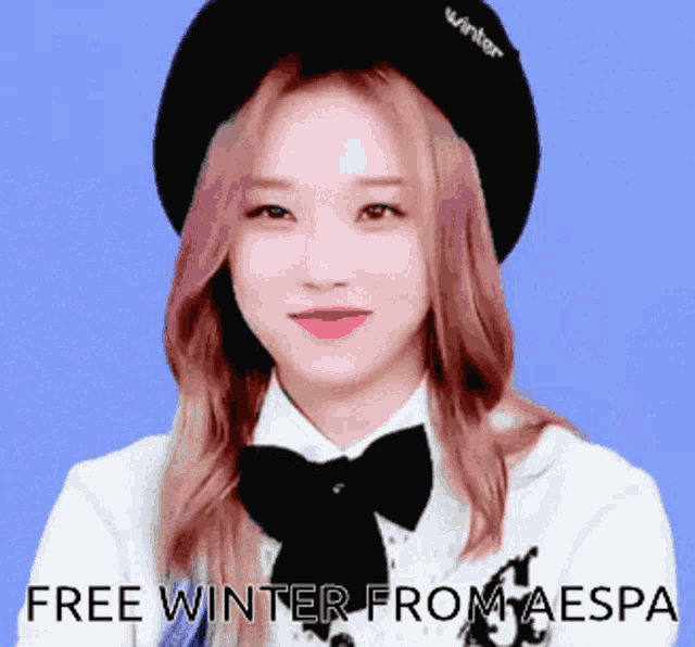 a woman wearing a beret and a bow tie with the words free winter from aespa