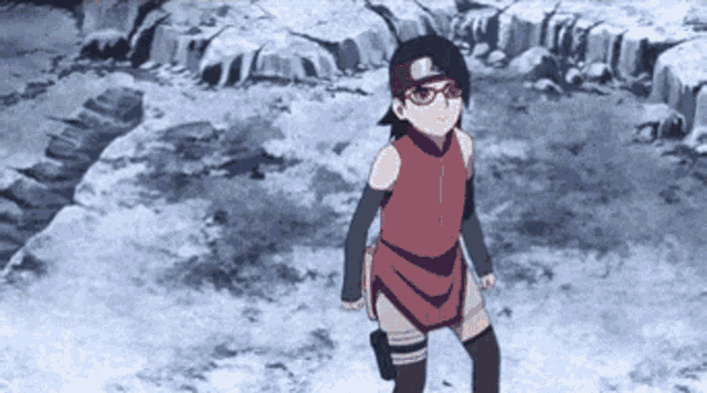 a girl in a red dress is standing in a snowy area .
