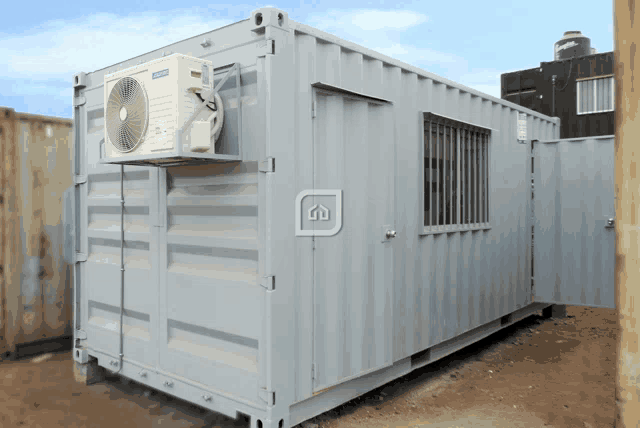 a gray container with an air conditioner mounted on the side