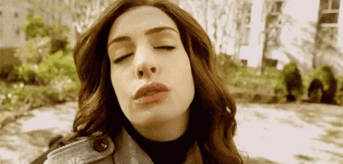 a woman with her eyes closed is making a funny face .
