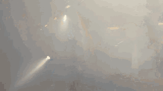 a fireman in a parking garage with a hose and a flashlight