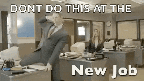 a man in a suit and tie is sitting on a desk in an office .