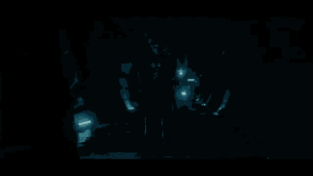 the sun is shining through the water in a dark room