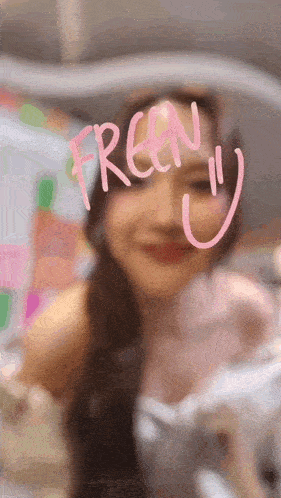 a close up of a woman 's face with the word freen written on a glass .