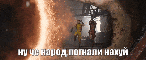 a man in a yellow suit is standing next to another man in a black suit in a cave