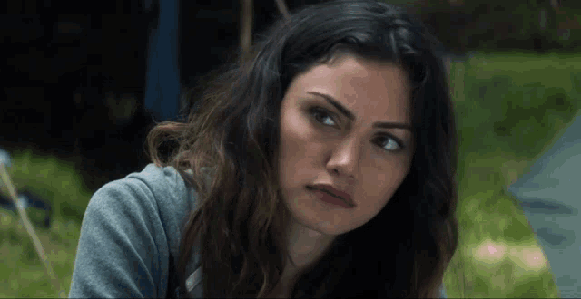 a close up of a woman 's face looking at the camera