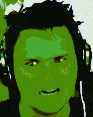 a close up of a man 's face with a green glow