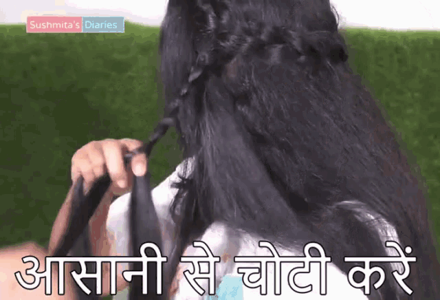 a woman 's hair is being braided and the words sushmita 's diaries are visible in the background