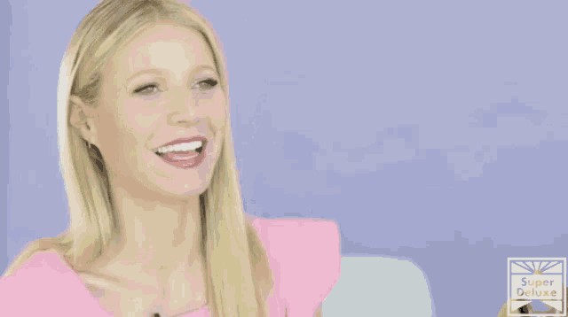 a woman in a pink top is talking about having martinis