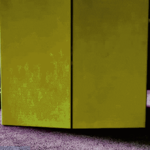 a yellow door is open to a purple carpet