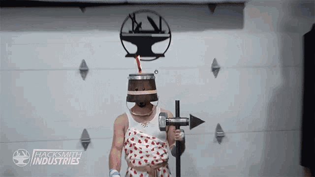 a man with a bucket on his head is holding a cross in front of a hacksmith industries logo