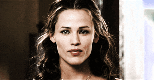 a close up of a woman 's face with a serious look on her face