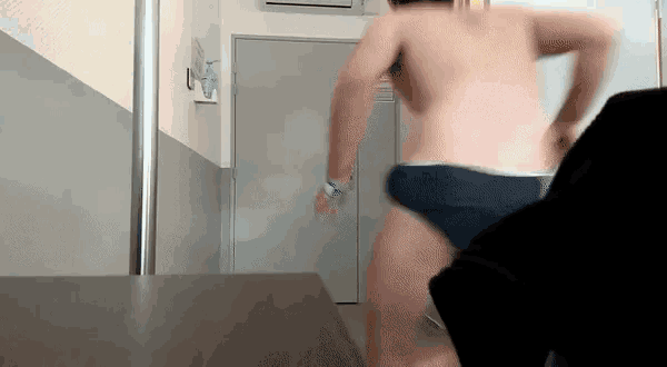 a man without a shirt is running in a room .