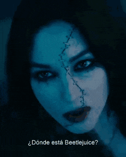 a woman with stitches on her face and the words donde esta beetlejuice