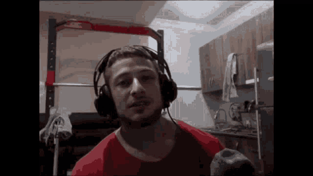 a man wearing headphones and a red shirt