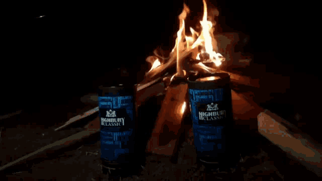 two cans of highbury classic next to a fire