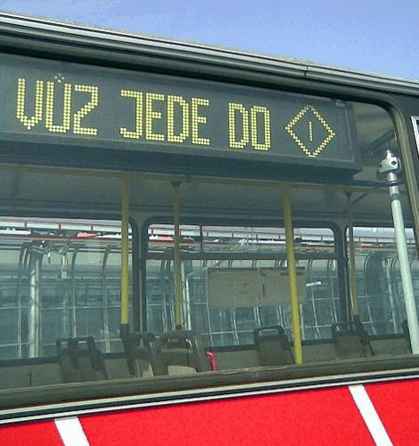 a red and white bus with a sign that says u12 jede do