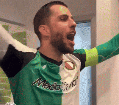 a man is wearing a green and white jersey with the word media on it