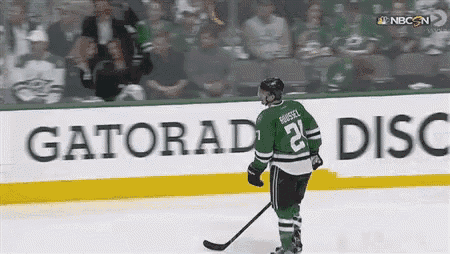 a hockey player with the number 21 on his jersey is standing on the ice