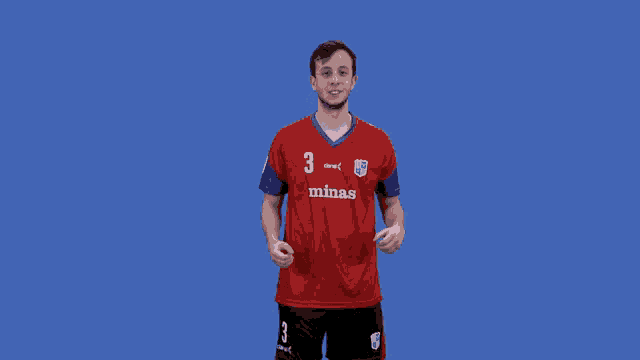 a man wearing a red minas jersey with the number 3 on it