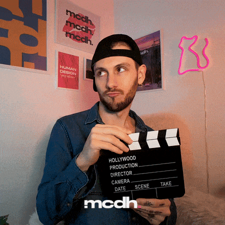 a man holding a clapper board that says hollywood production director camera date and scene