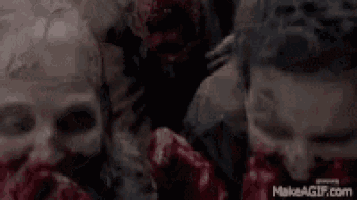 a group of zombies with skulls on their faces are standing next to each other .