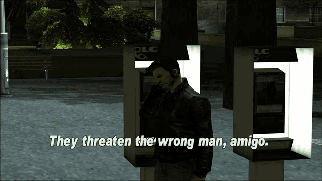 a man talking on a phone with the words they threaten the wrong man amigo below him