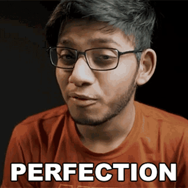 a man wearing glasses and an orange shirt has the word perfection written on his face