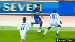a group of soccer players are playing on a field with an ad for seven in the background