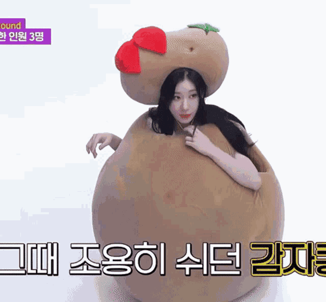 a woman is wearing a costume of a potato with a red flower on it .