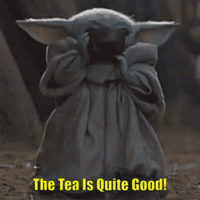 a baby yoda is holding a cup of tea and saying the tea is quite good