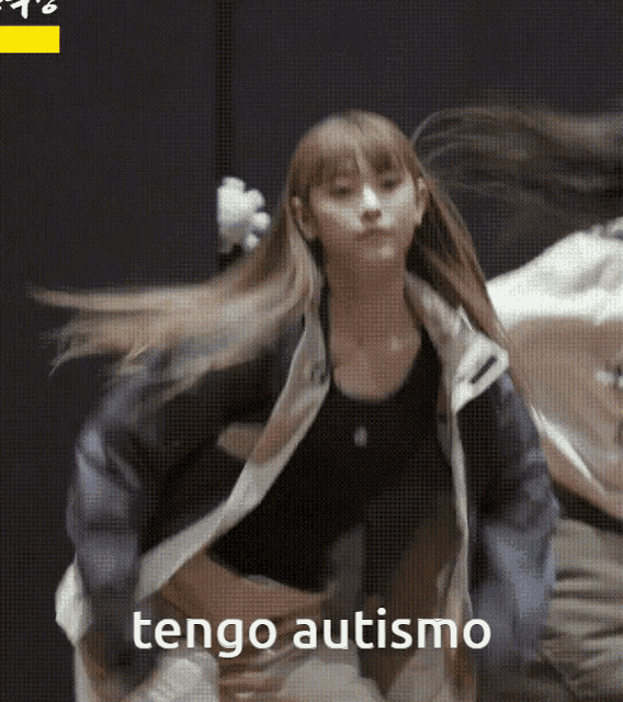 a woman is dancing with the words tengo autismo in the corner