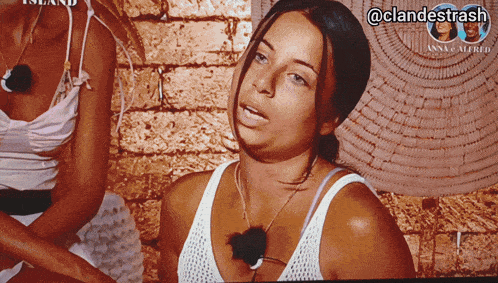 a woman is sitting in front of a brick wall with the hashtag @clandestrash on the bottom right