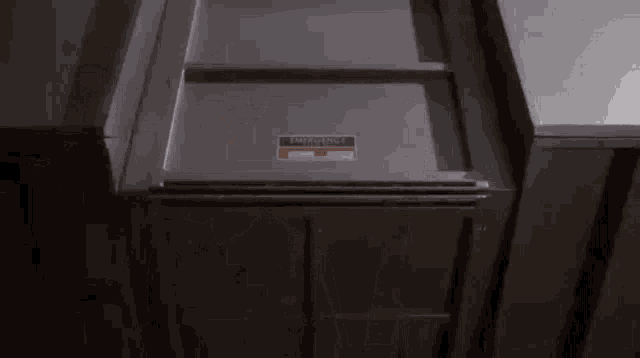 a stainless steel refrigerator with an emergency sticker on it