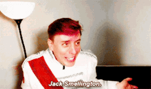 a man with pink hair says jack smellington while sitting on a couch