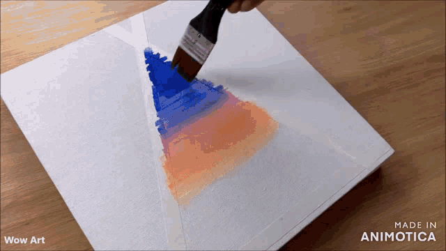 a brush is being used to paint a triangle on a white canvas