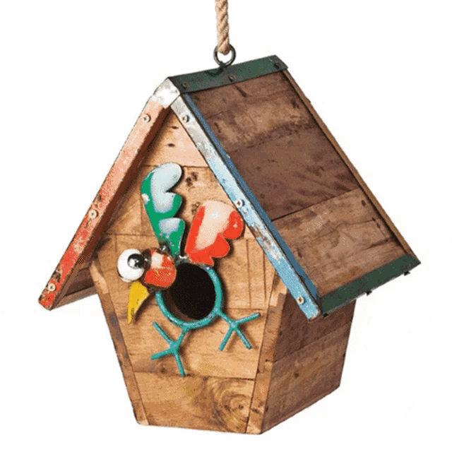 a wooden birdhouse with a colorful bird on the roof