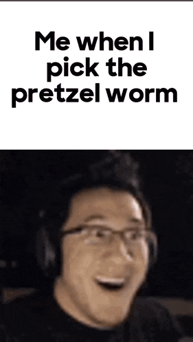 a man wearing headphones is making a funny face while holding a pretzel worm .
