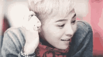 a man with short hair is talking on a cell phone .