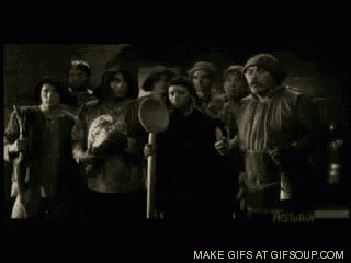 a group of people are standing next to each other in a dark room .