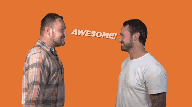 two men are giving each other a high five and one is wearing a plaid shirt
