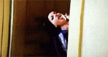 a pixelated image of a person looking out a doorway