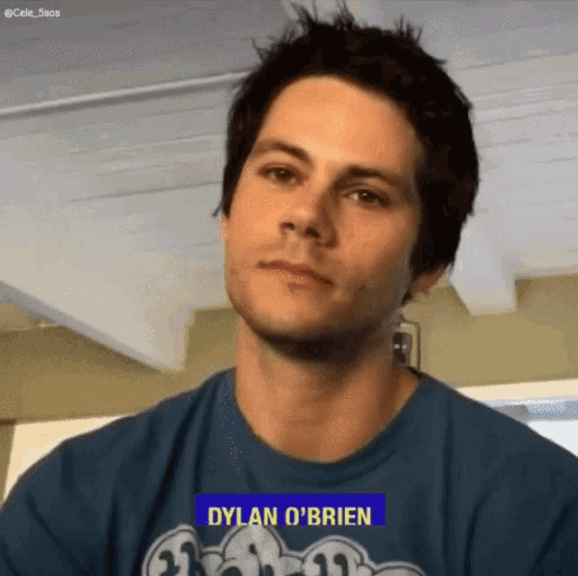 a man wearing a blue shirt with the name dylan o 'brien on it