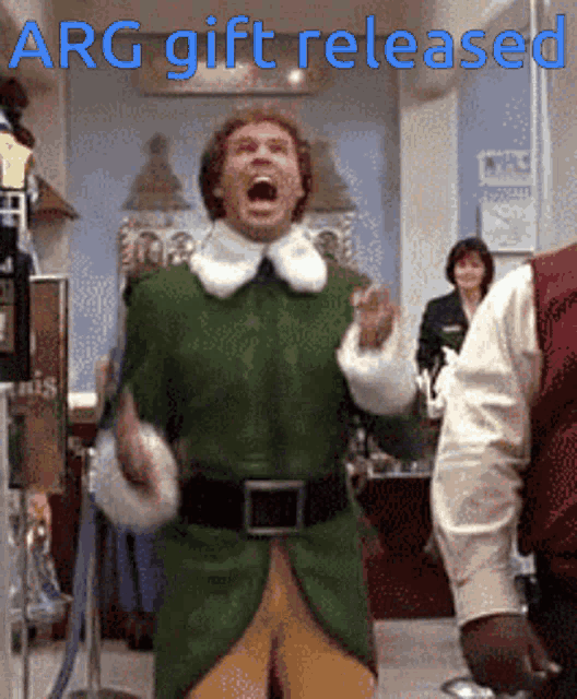 a man in a green elf costume is screaming with arg gift released written in blue