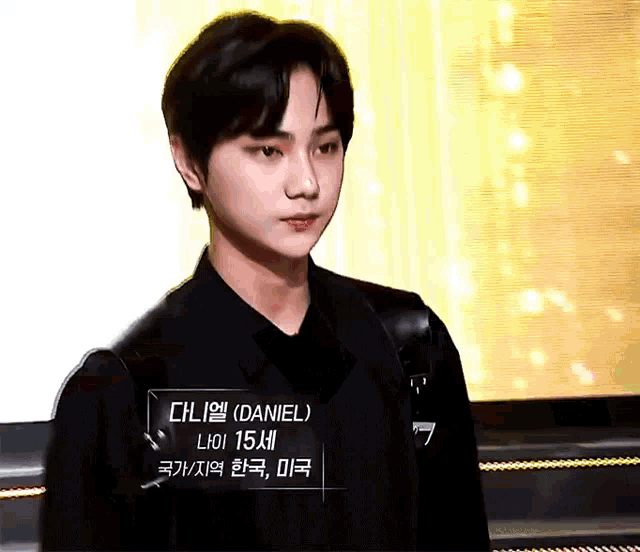 a young man wearing a black shirt with a name tag that says daniel on it