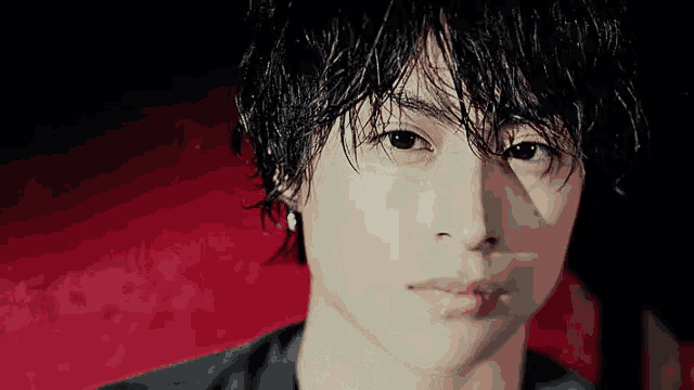 a close up of a man 's face with wet hair